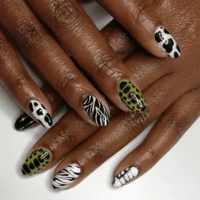 A zebra print manicure with a glittery base