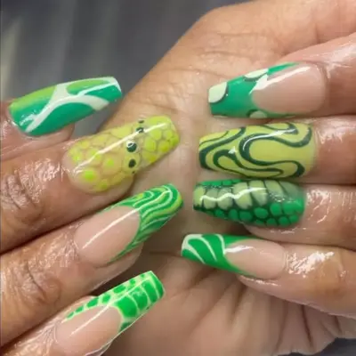 a mismatched manicure with various prints in green