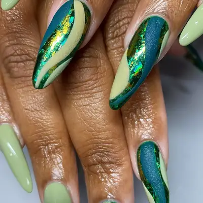 Long green nails with metallic and shimmery accents