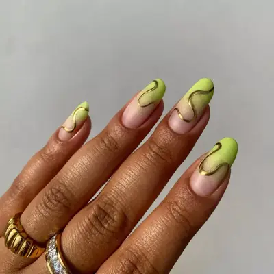 ombre green round shaped nails with gold chrome curvy lines