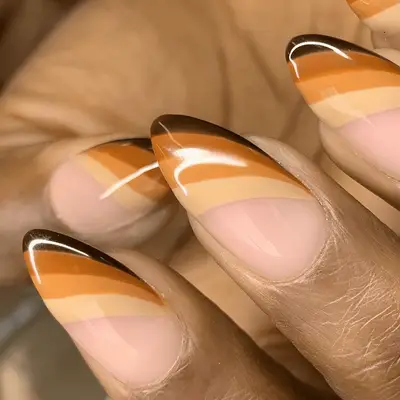 asymmetric striped manicure in shades of brown