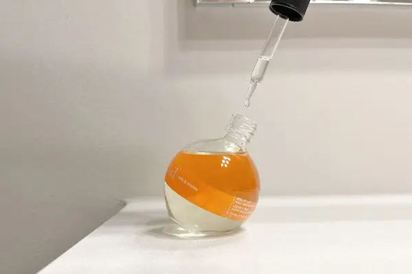 Cuccio Milk and Honey Revitalizing Cuticle Oil with its dropper top removed 