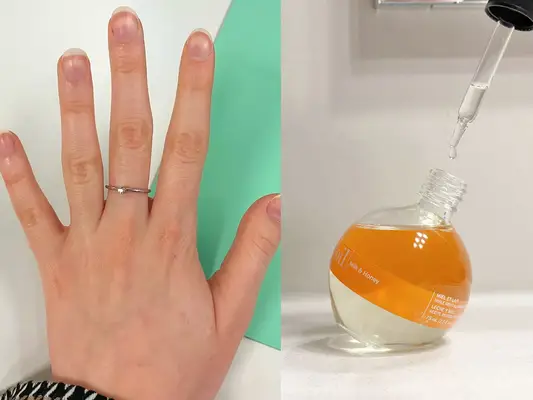Close-up of a hand with nails covered in cuticle oil against a white and green background and Cuccio Milk and Honey Revitalizing Cuticle Oil with its dropper top removed 