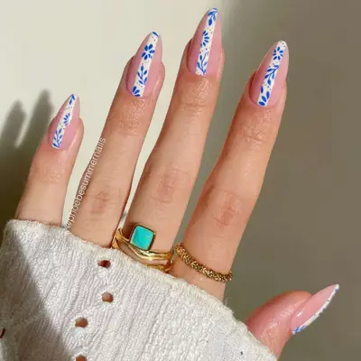 Nude manicure with a line down the middle of each nail with a sliver of French toile design.