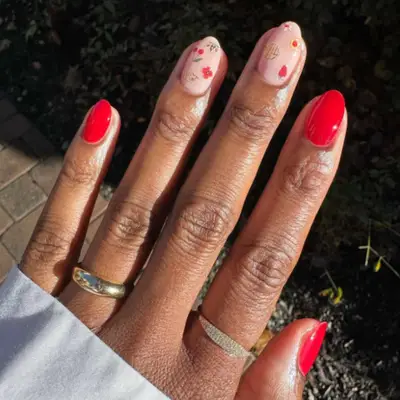 Red manicure with nude accent nails.