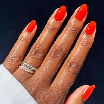 Orange red nails.