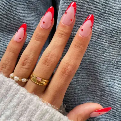 Gem-ed out red French manicure.
