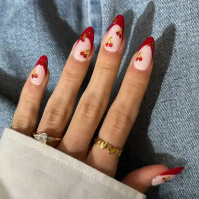 French manicure with red tips and cherries.