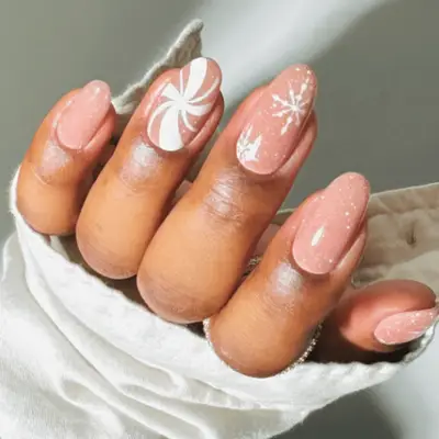 pink glitter nails with snowflake and peppermint accent designs