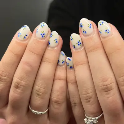 Cream base nail polish with blueberry nail art on top