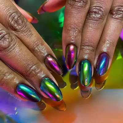 a multicolored chrome manicure with shades include green, blue, purple, and pink