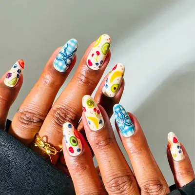 Decoratively manicured nails featuring colorful artistic designs on each nail