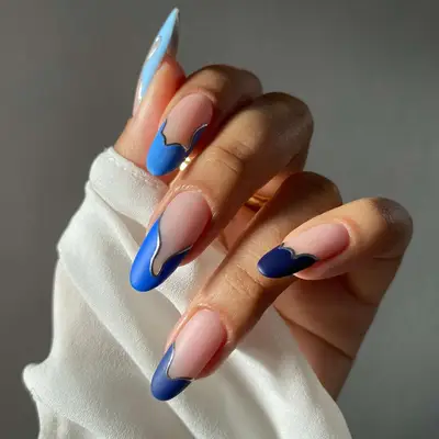 close up of french tip nails in different shades of blue