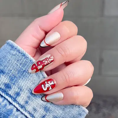 woman with san francisco 49ers-inspired manicure