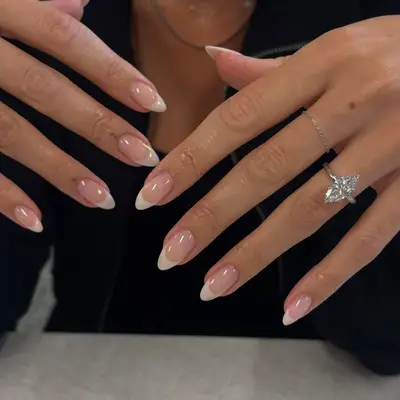 Hands with manicured nails and a diamond ring