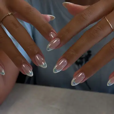 Hands with manicured nails featuring detailed designs