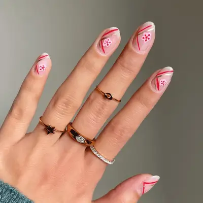 A close up of Lunar New Year inspired nails with cherry blossom details.