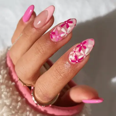 A close up of retro pink floral nails with pink French tips.