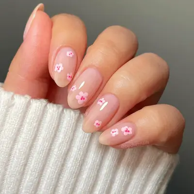 Close up of nude short nails with abstract cherry blossoms. 