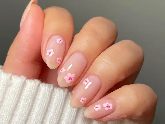 Close up of nude short nails with abstract cherry blossoms. 