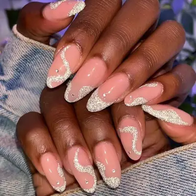 Studded French manicure with small rhinestones and wavy silver glitter tips