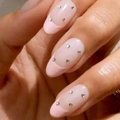 Studded French manicure with ballerina pink tips and clear rhinestones