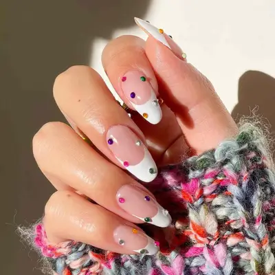 French manicure with colorful rhinestone studs