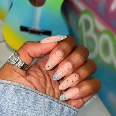 Silver glitter studded French manicure with star decals