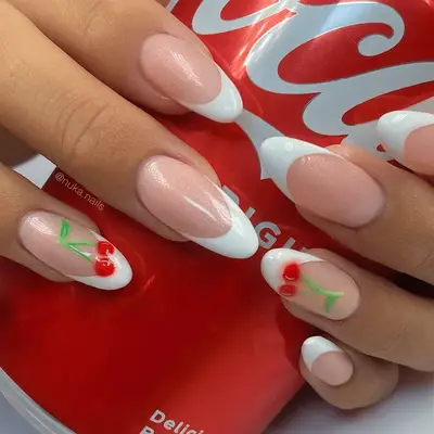 Almond shaped nails with cherry detail holding Coke can