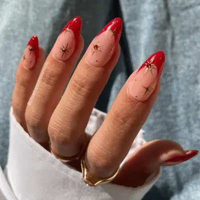 red french nails with gold chrome stars