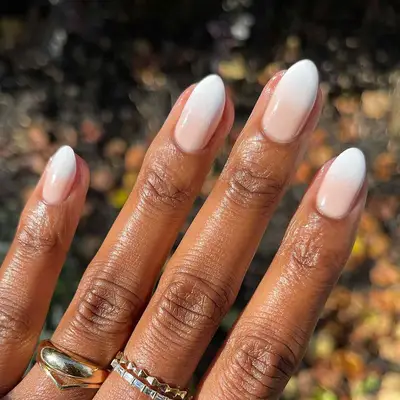 a neutral manicure with ombre white tips