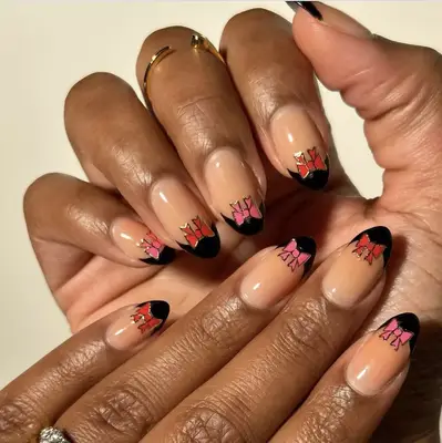 black french manicure topped with red and pink bows