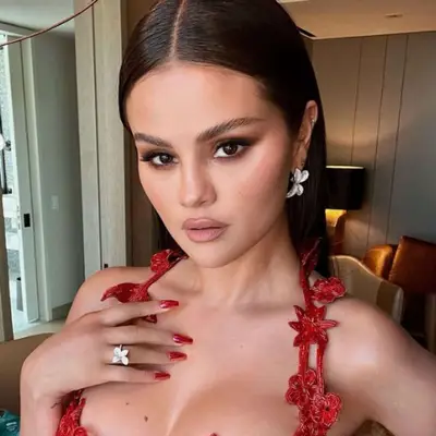 Selena Gomez with metallic red chrome nails.