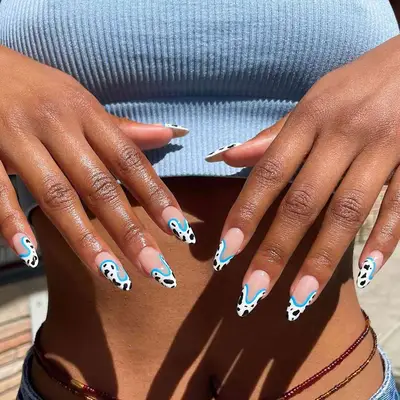 Wavy cow print French manicure with blue outline