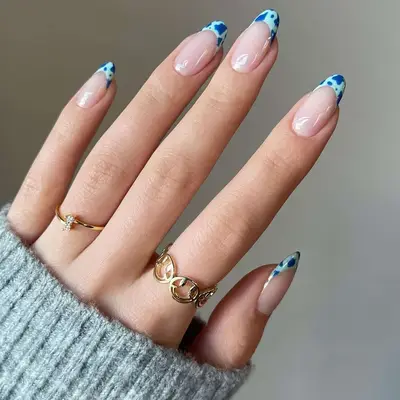 Blue cow print French manicure