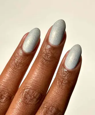 Close-up of manicure with abstract silver chrome nail design