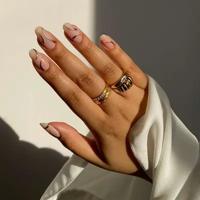 Gold accent curved lines on neutral nail
