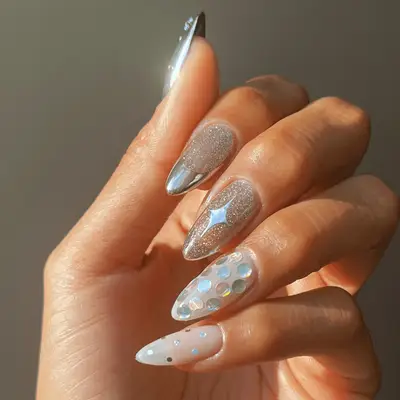 Close-up of manicure with half purple glitter polish and black art deco French tips