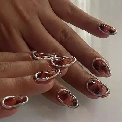 Tortoiseshell nails with chrome borders.