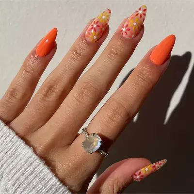 flower design nails with orange accent nails