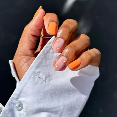 short orange nails with orange flower accent nails