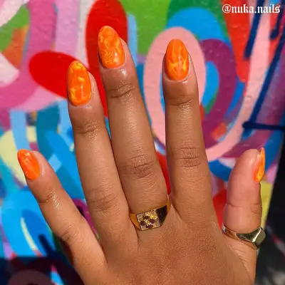 orange and yellow fire short almond-shaped nails
