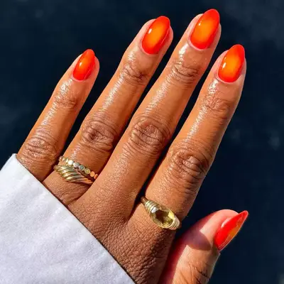 short orange nails with yellow center