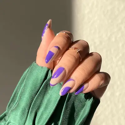 A purple manicure with negative space details