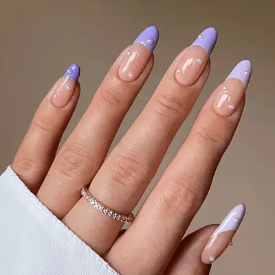 A gradient purple French manicure with pearl details