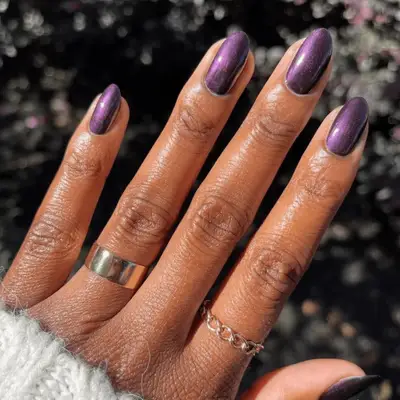 Close up of a glazed purple plum manicure