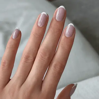 Close up of French manicure with a lilac base color.