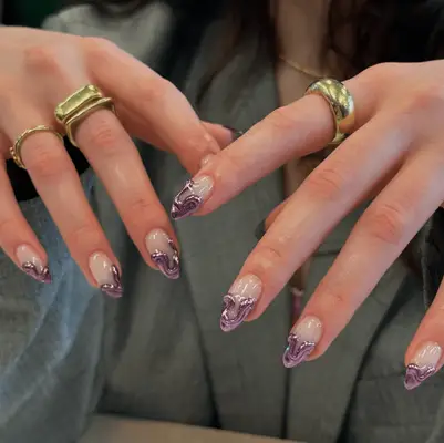 Short, almond shaped nails with 3D purple chrome