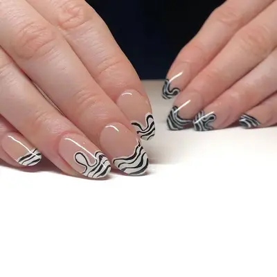 Nude nails with swirly black-and-white striped tips