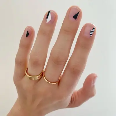 Short black-and-white nails with triangle accents